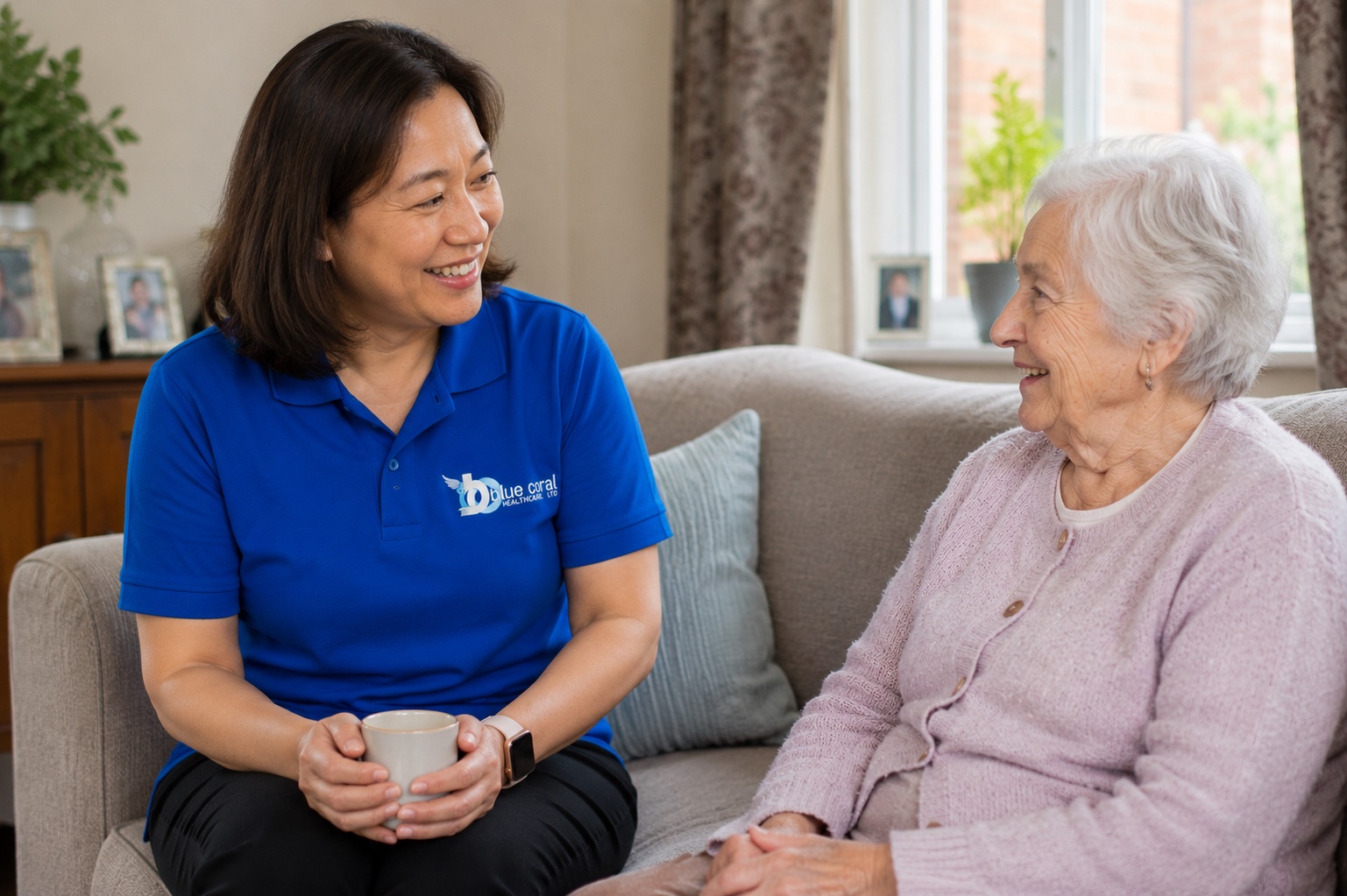 Blue Coral Healthcare carer talking warmly with an elderly client at home