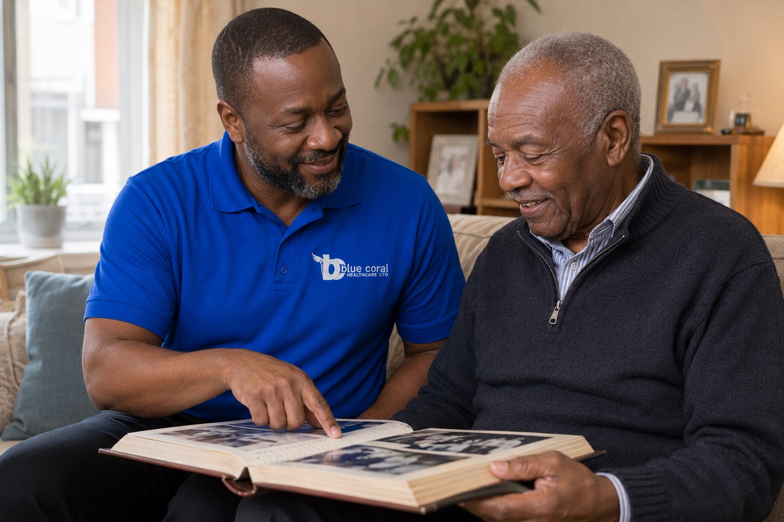 Blue Coral Healthcare carer using a photo album to support memory for a man with dementia