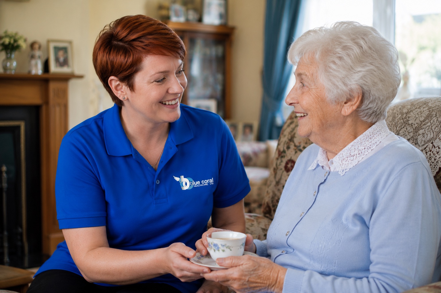 Blue Coral Healthcare carer supporting an elderly woman with a cup of tea at home in Sheffield