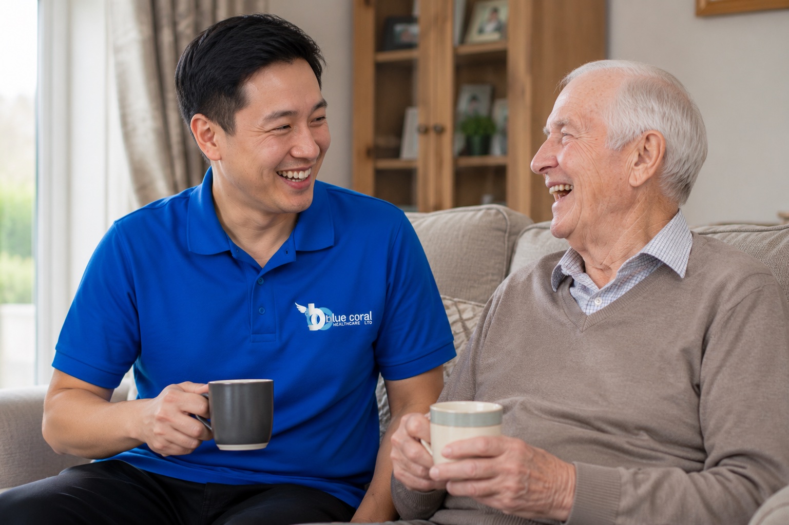 Blue Coral Healthcare carer enjoying companionship with an elderly man at home in Kirklees